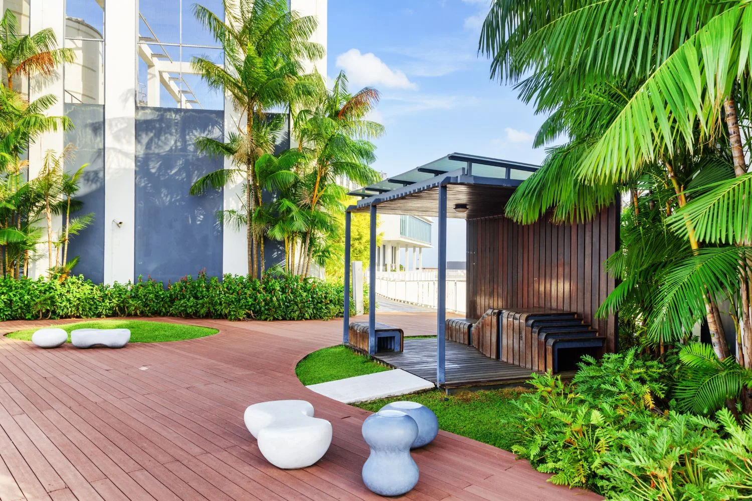A tropical outdoor pergola and deck area