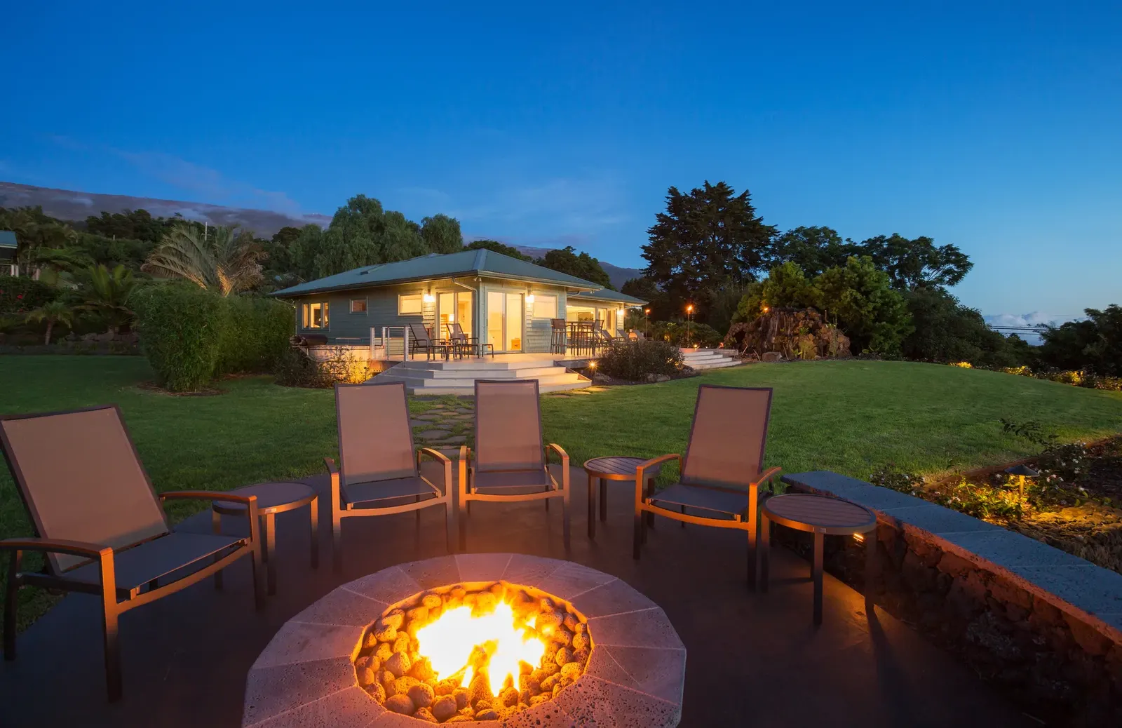An outdoor fire pit built into a pergola area
